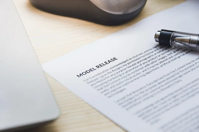 paper, model release, form, document, signing, pen, desk, agreement, business, contract, signature. How UK GDPR and model releases work on British product shoots